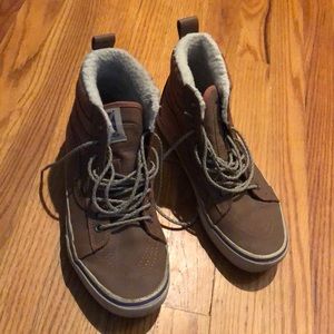 Tan leather and fuzzy high top vans